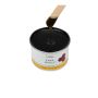 Applicator stick dipped into & drawn from a can of GiGi Dark Honee dripping with pitch dark brown wax thumbnail